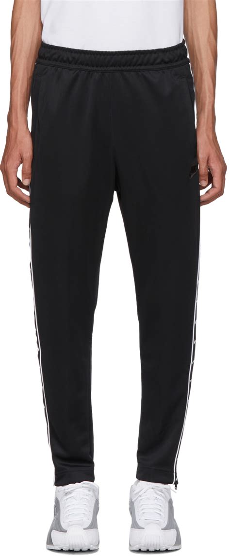 Nike: Black Swoosh Tape Track Pants 